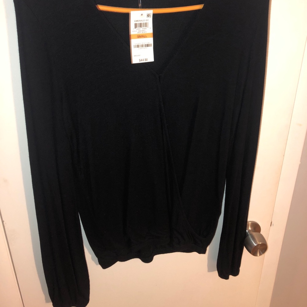 Long sleeve black shirt. Opening in the middle. Size small. Never worn. Tags on.